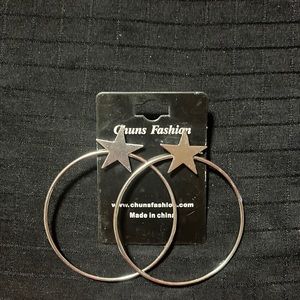 Silver toned stars atop large hoop earrings